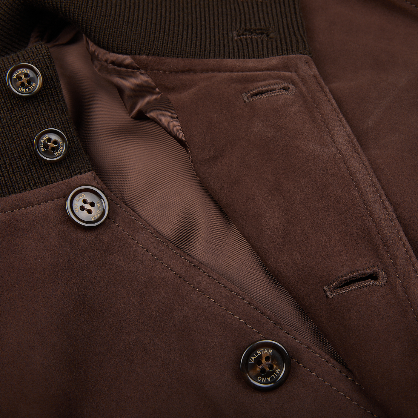 Close-up of a dark brown suede leather Valstarino jacket by Valstar with buttons.