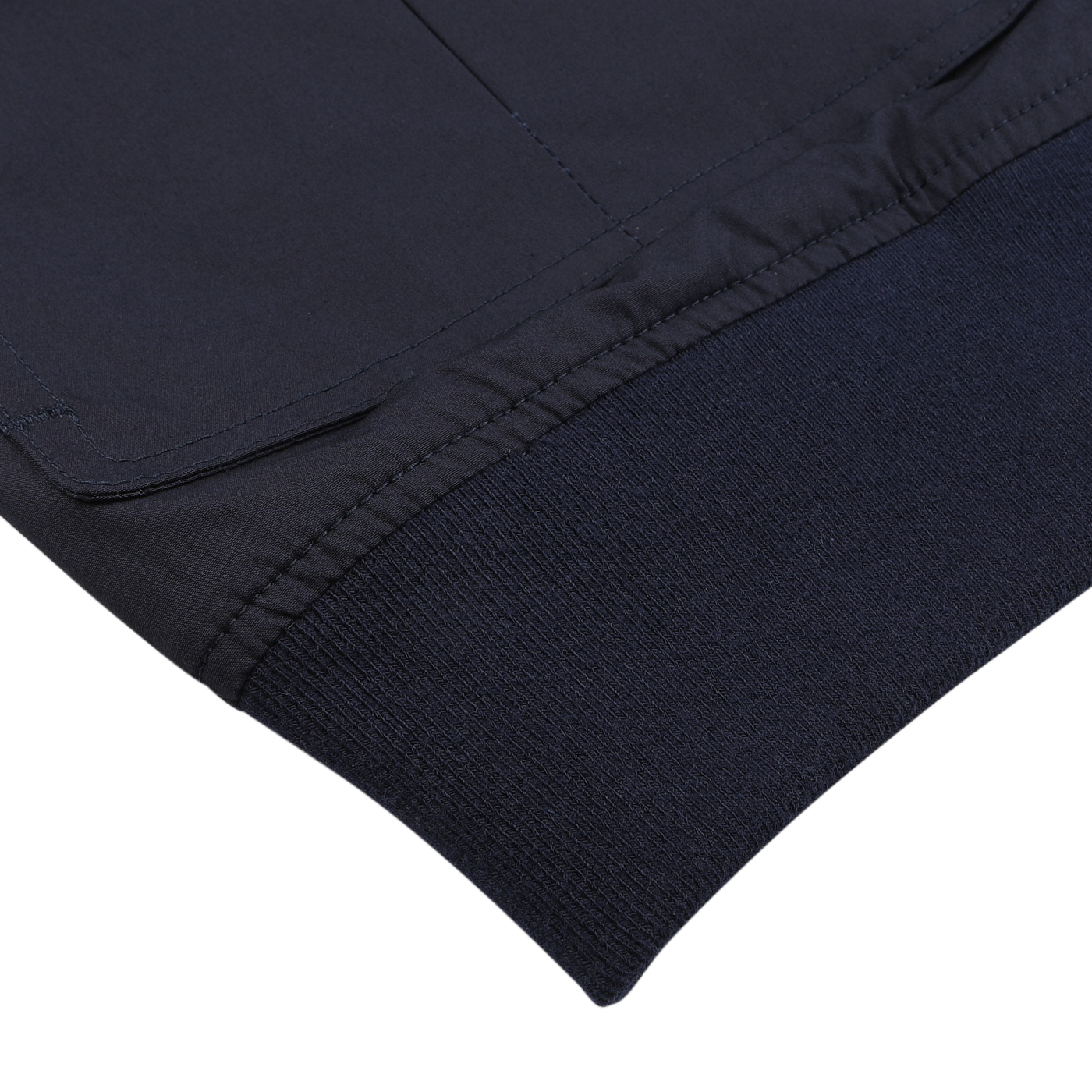 Close-up of a Navy Blue Cotton Poplin Valstarino Jacket sleeve by Valstar, highlighting the exquisite stitching and ribbed cuff, crafted from stretch cotton against a pristine white background.