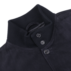 Close-up of a navy blue suede leather Valstarino jacket by Valstar, showcasing a ribbed collar and three black buttons.