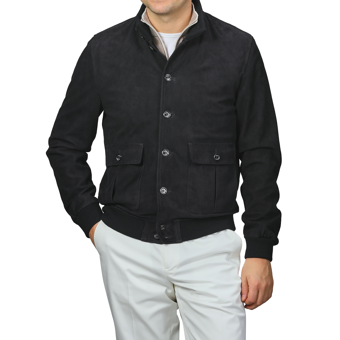 A man in a navy blue suede leather Valstarino jacket by Valstar and white pants stands against a plain background.