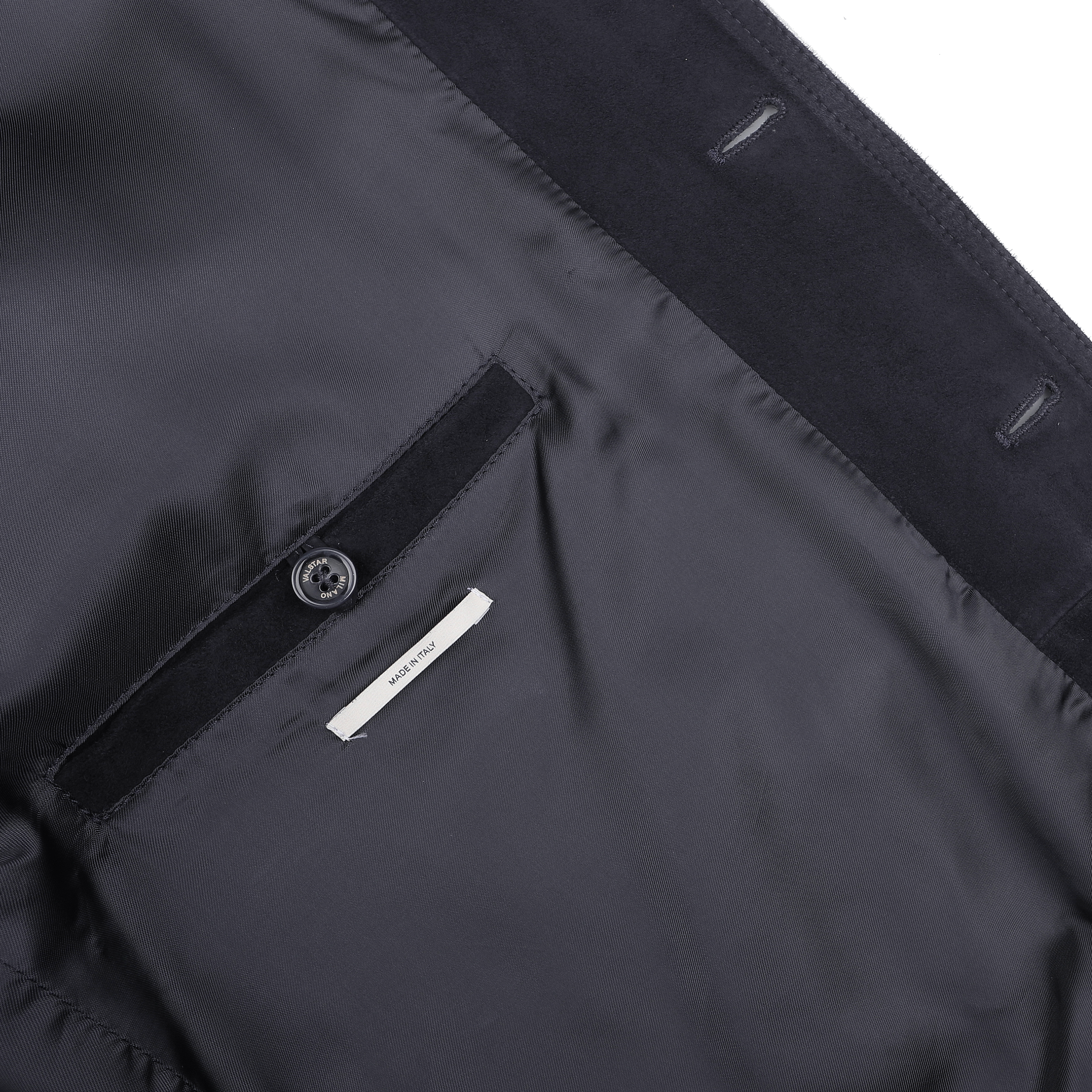 The interior of the Navy Blue Suede Leather Valstarino Jacket by Valstar features a buttoned pocket and a visible clothing label, showcasing its classic design.