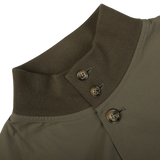 Close-up of a Valstar Olive Green Cotton Ripstop Valstarino Jacket with a ribbed collar and metallic buttons.
