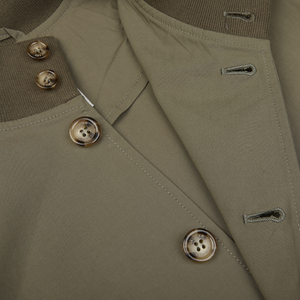 Close-up of an olive green cotton ripstop Valstarino jacket with button details.