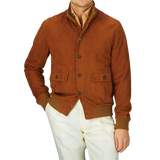 Man wearing a Valstar Sandal Brown Suede Leather Valstarino jacket and white trousers.