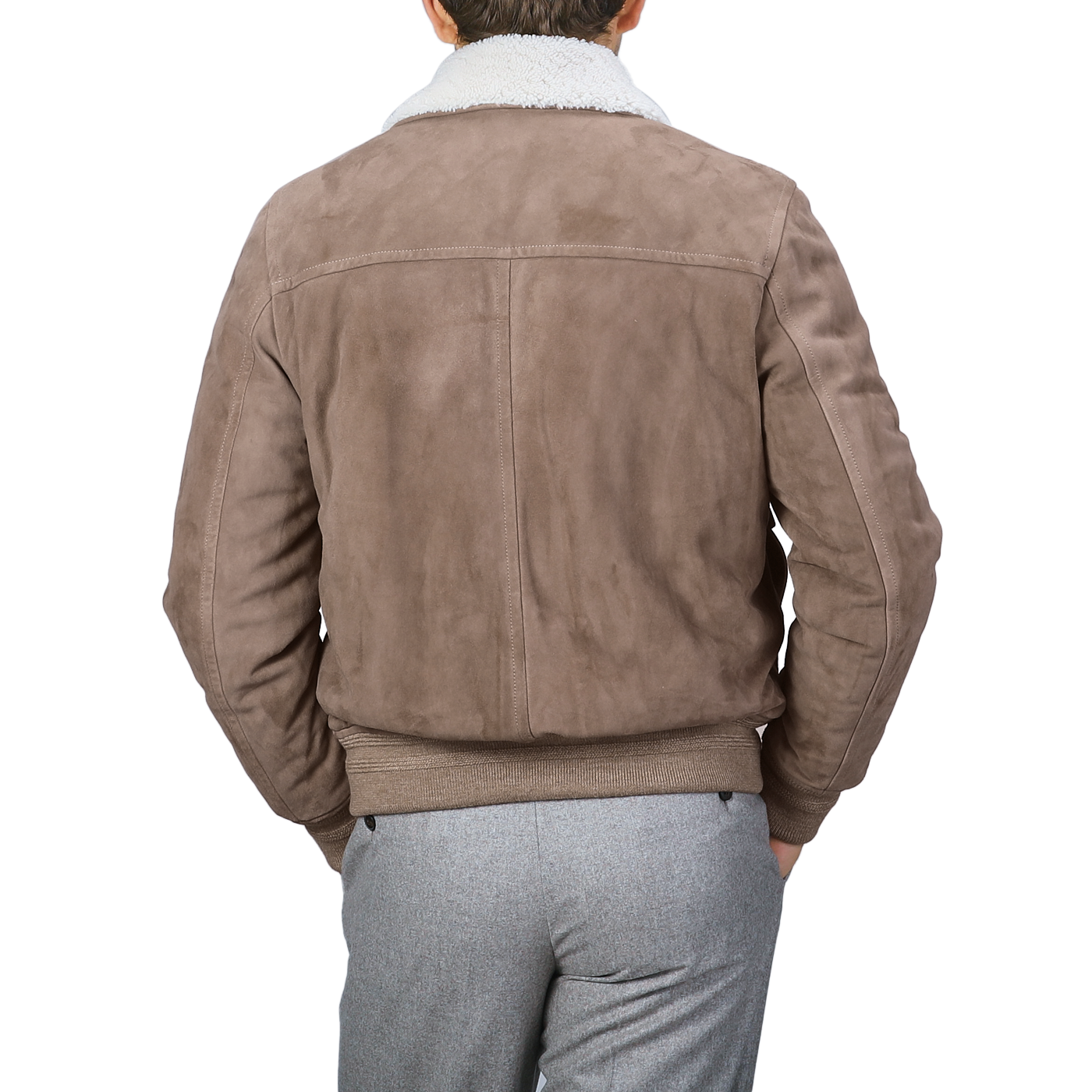 A person is seen from the back wearing the "Taupe Suede Leather Shearling Flight Jacket" by Valstar, paired with gray pants.