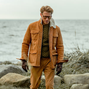 A man wearing a camel beige suede leather Liam jacket by Werner Christ with fur lining.