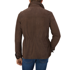 The back view of a man wearing a Dark Brown Suede Anton Leather Jacket, crafted with expertise by Werner Christ, a leather specialist.