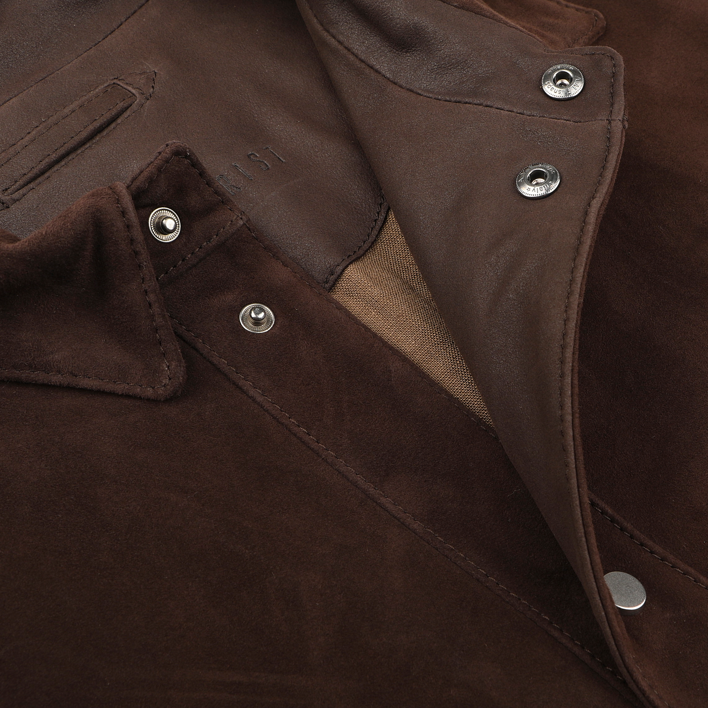 Close-up of a Dark Brown Suede Leather Amaro Shirt Jacket by Werner Christ, highlighting the metal snap buttons, interior fabric, and collar detail.