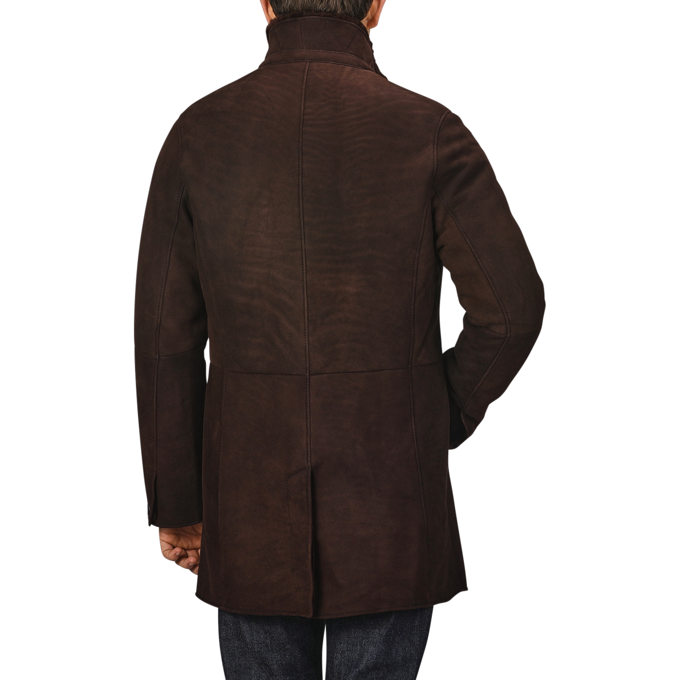 A person wearing a dark brown suede leather Blake coat by Werner Christ, viewed from the back with one hand in their pocket.