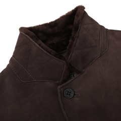 Close-up of the Werner Christ Dark Brown Suede Leather Blake Coat, featuring a button closure and plush inner lining, perfect for winter weather.