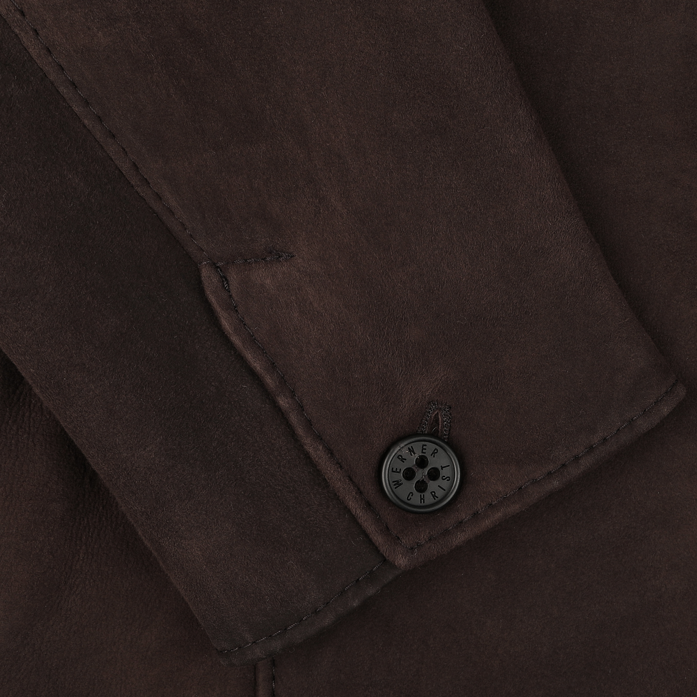 Close-up of a sleeve on the Werner Christ's Dark Brown Suede Leather Blake Coat, featuring a single black button stitched near the cuff.