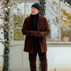 A man wearing a Dark Brown Suede Leather Blake Coat by Werner Christ.