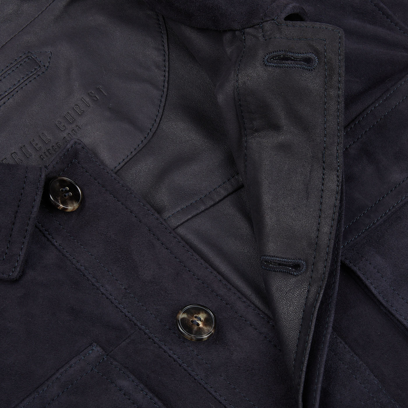 A close up image of a Werner Christ Navy Suede Anton Leather Jacket with buttons.