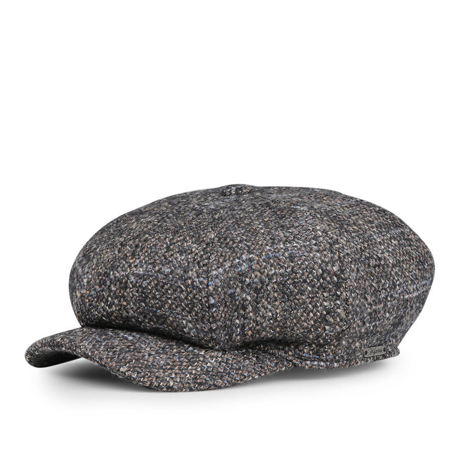 A contemporary blue melange wool cap by Wigéns is displayed elegantly on a white background.