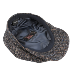 A Blue Melange Wool Ivy Contemporary Cap by Wigéns, crafted from a contemporary wool blend, features a dark satin lining and brand labels on the interior.