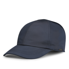 The Blue Nylon Fleece Lined Baseball Cap by Wigéns is made from technical nylon, showcasing a dark blue hue with a curved brim and a textured seam design.