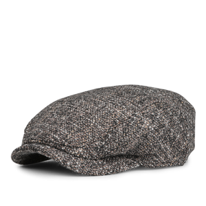 A side view of Wigéns' Brown Melange Wool Ivy Contemporary Cap, featuring a textured wool blend in gray and brown shades.