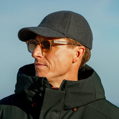 A man wearing a Green Loro Piana Wool Cashmere Baseball Cap by Wigéns.