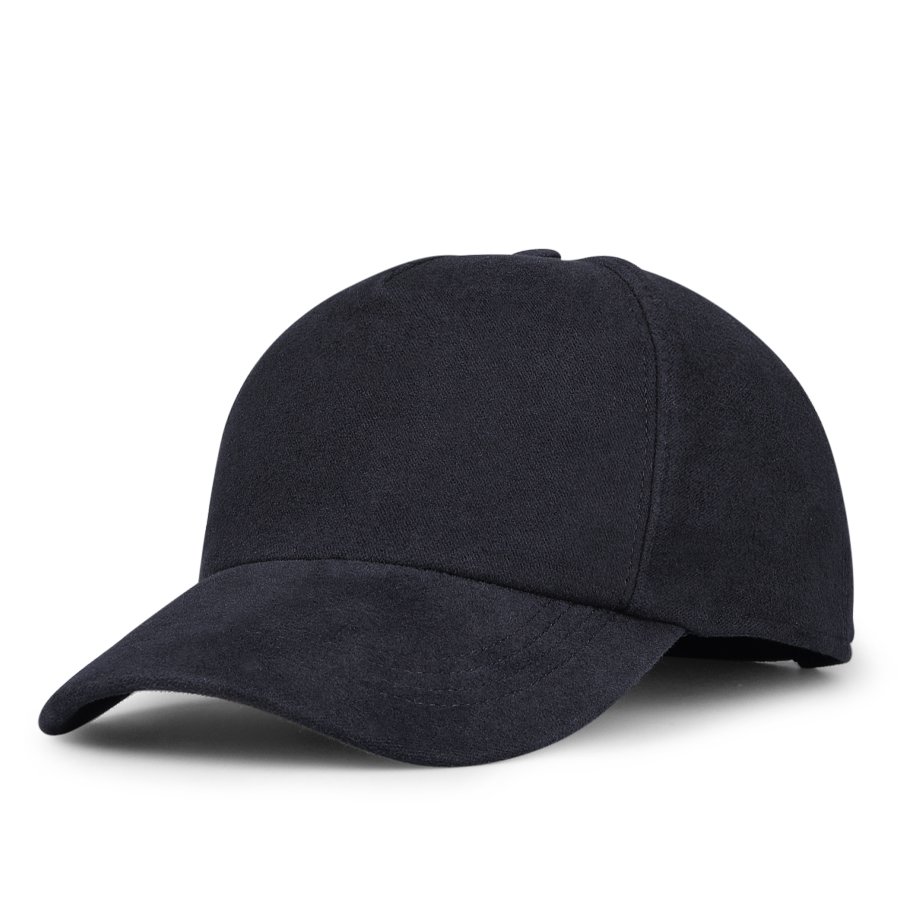 The Navy Blue Cotton Moleskin Baseball Cap by Wigéns stands out against the white background, adding a touch of classic style with its curved brim.