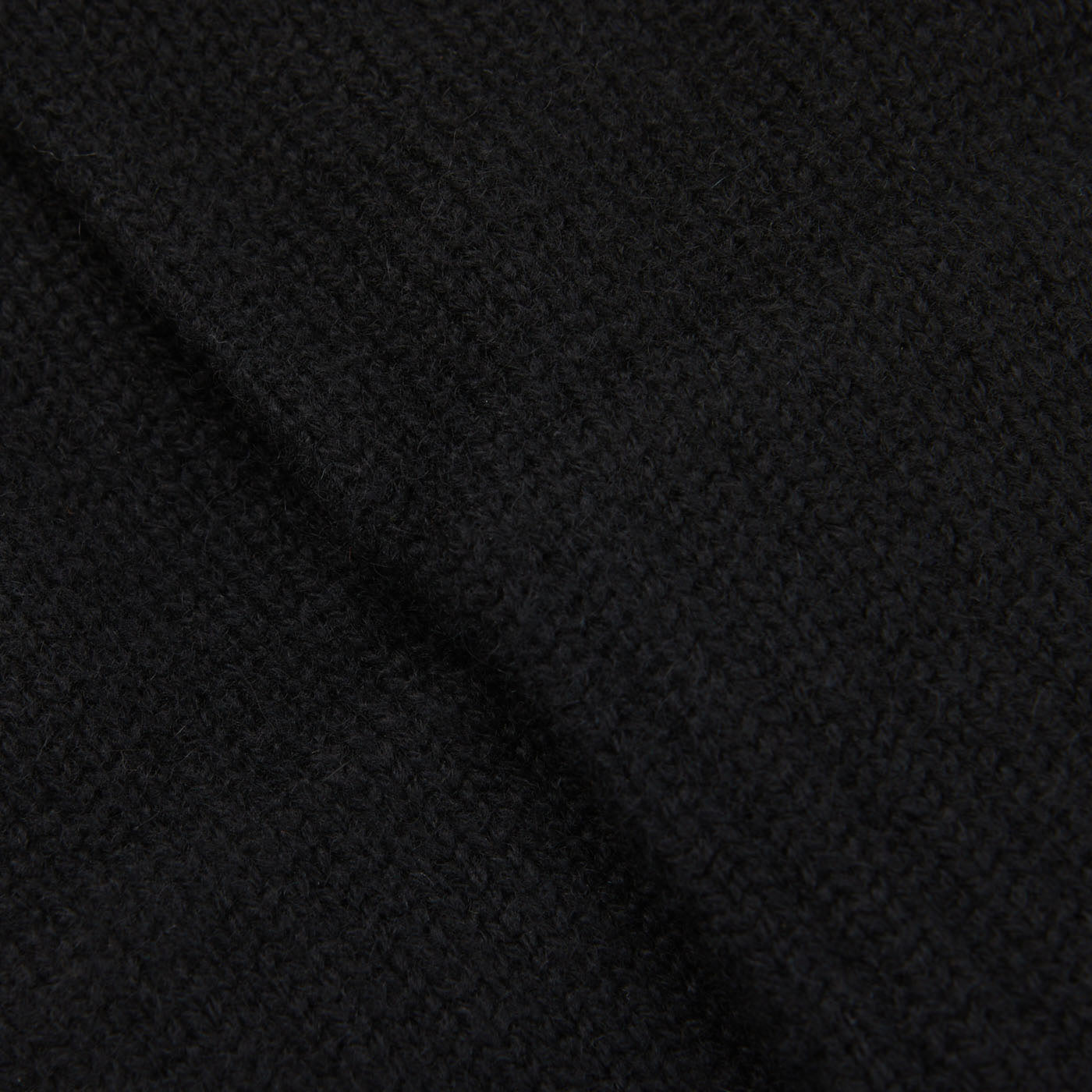 A close up image of a black William Lockie cashmere scarf.