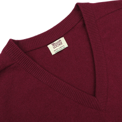 A close-up image of a Bordeaux Deep V-Neck Lambswool Sweater by William Lockie, made from 100% pure Geelong wool.