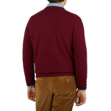 The back view of a man wearing a William Lockie Bordeaux V-Neck Lambswool Sweater.