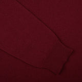 A close up of a William Lockie Bordeaux V-Neck Lambswool Sweater.