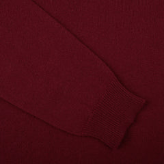 A close up of a William Lockie Bordeaux V-Neck Lambswool Sweater.