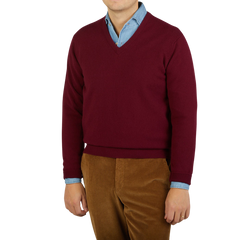 A man wearing a comfy Bordeaux V-Neck Lambswool sweater by William Lockie.