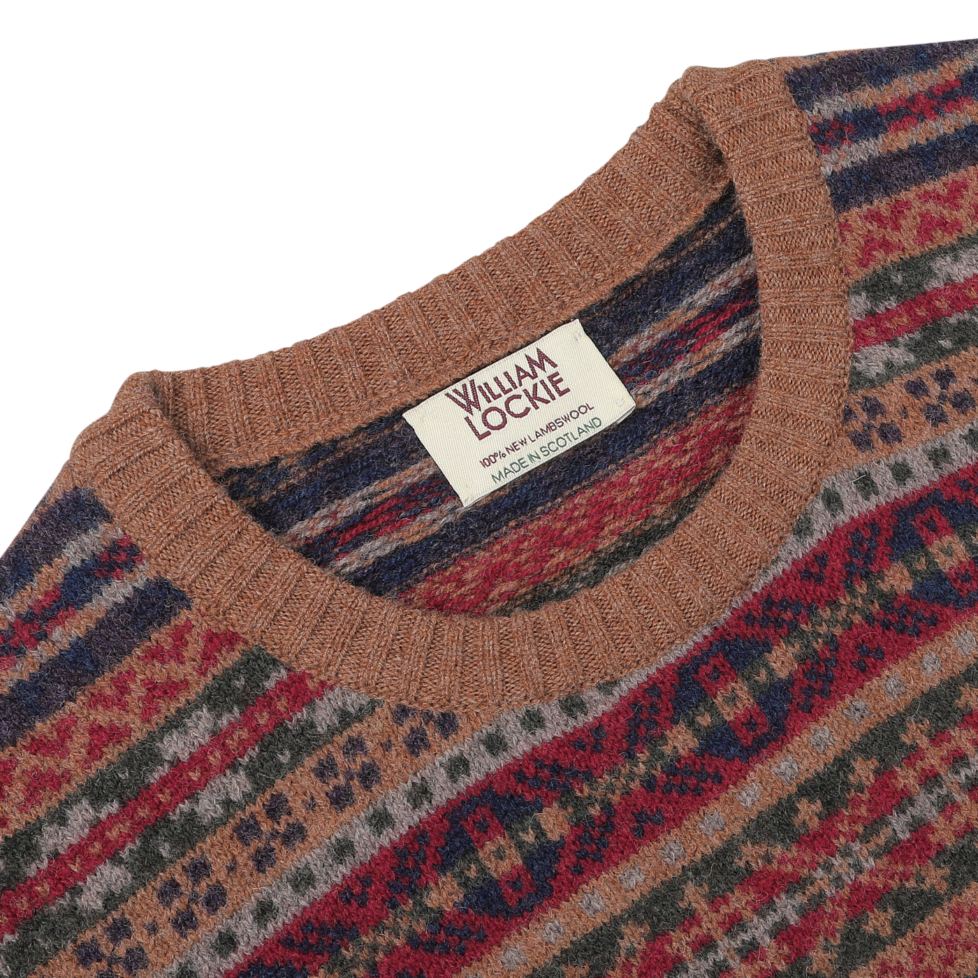 Close-up of a William Lockie label on the Brown Fair Isle Crew Neck Lambswool Sweater, showcasing "Made in Scotland" text on a cream-colored tag of this pure Scottish lambswool masterpiece.