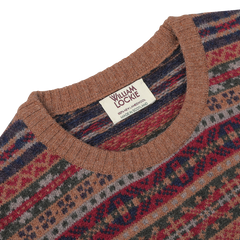 Close-up of a William Lockie label on the Brown Fair Isle Crew Neck Lambswool Sweater, showcasing "Made in Scotland" text on a cream-colored tag of this pure Scottish lambswool masterpiece.