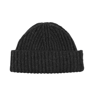 The Charcoal Grey Cashmere Ribbed Short Beanie by William Lockie is elegantly displayed against a plain white background, highlighting its luxurious cashmere material and ribbed knit design with a folded brim.