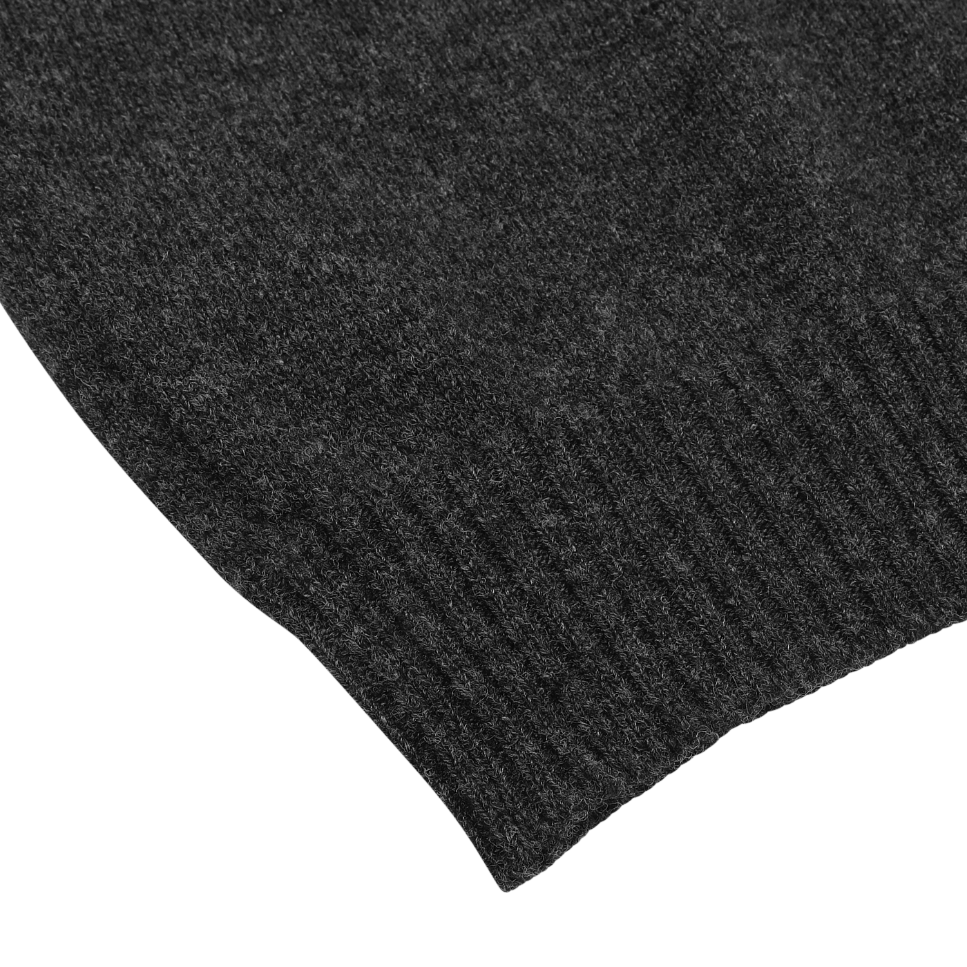 Close-up image of the ribbed hem section of the Charcoal Grey Crew Neck Lambswool Sweater by William Lockie. This luxurious Scottish lambswool sweater, showcased on a light grey background, is perfect for a smart casual look.