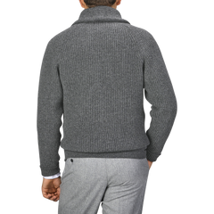 A man is seen from the back wearing a Cliff Grey Lambswool Shawl Collar Cardigan by William Lockie and gray pants.