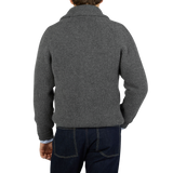 The back view of a man wearing a William Lockie Cliff Grey Lambswool Shawl Collar Cardigan with leather buttons.