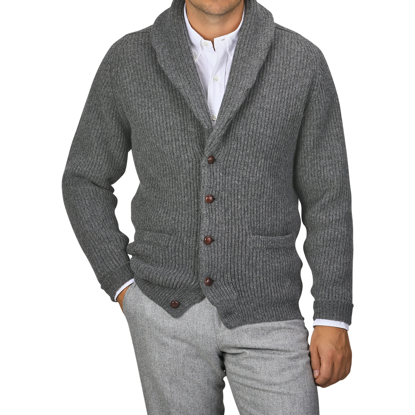 Person wearing a William Lockie Cliff grey lambswool shawl collar cardigan featuring brown buttons over a white dress shirt and grey pants. Only the torso and part of the arms are visible.