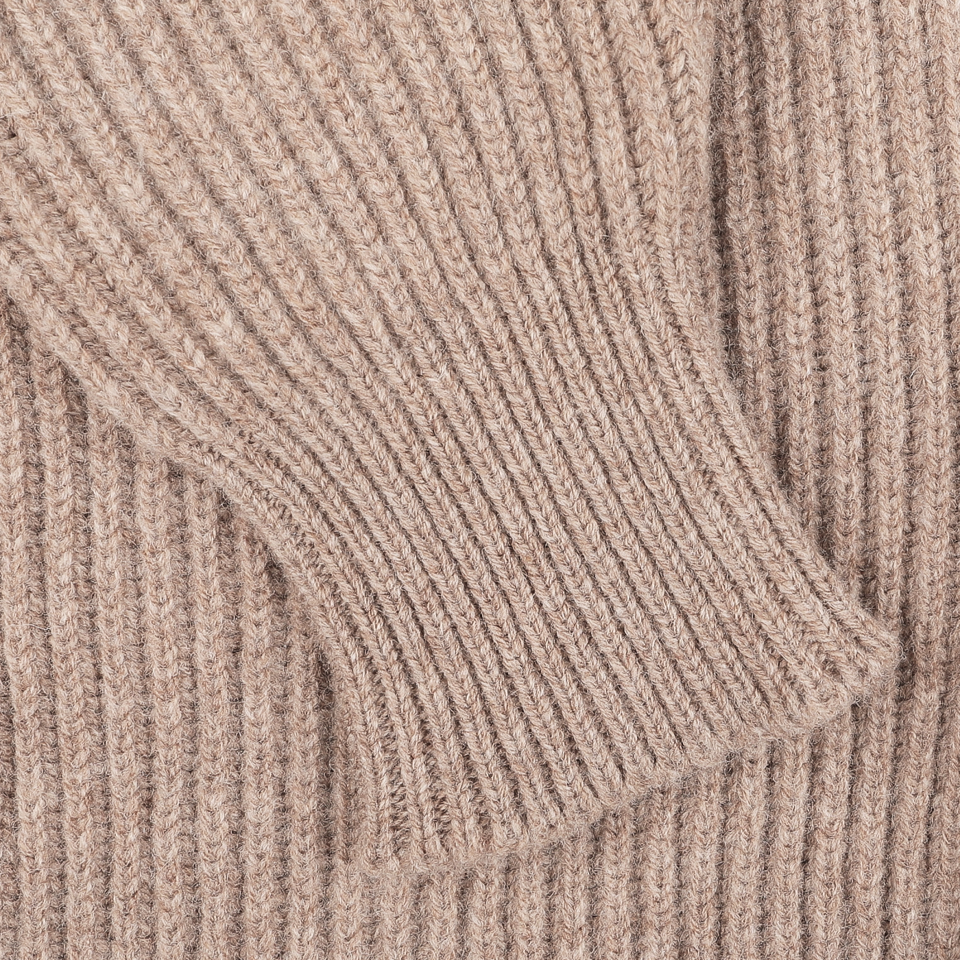 Close-up of a Colt Beige Lambswool Shawl Collar Cardigan by William Lockie, highlighting its ribbed knit texture. The focus is on the sleeve folded over the main fabric.