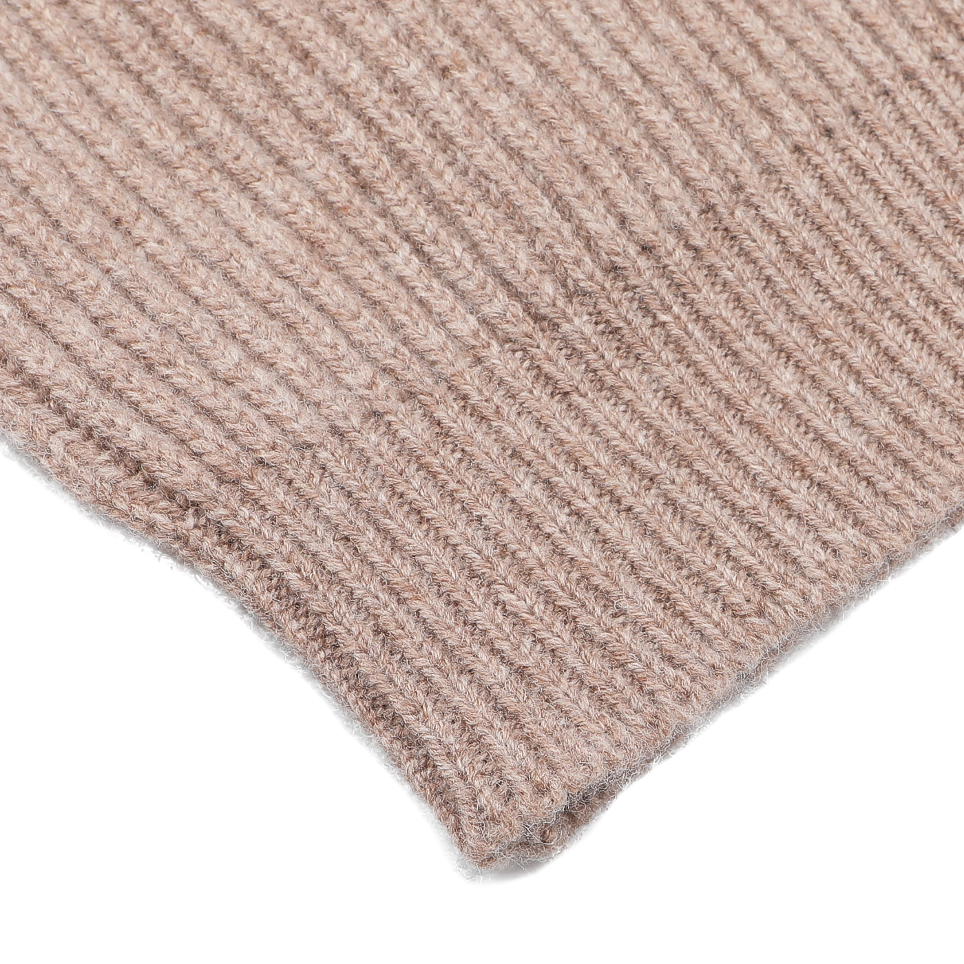 Close-up of a section of the Colt Beige Lambswool Shawl Collar Cardigan by William Lockie, showcasing its ribbed texture, made from Scottish lambswool, laid on a white surface.