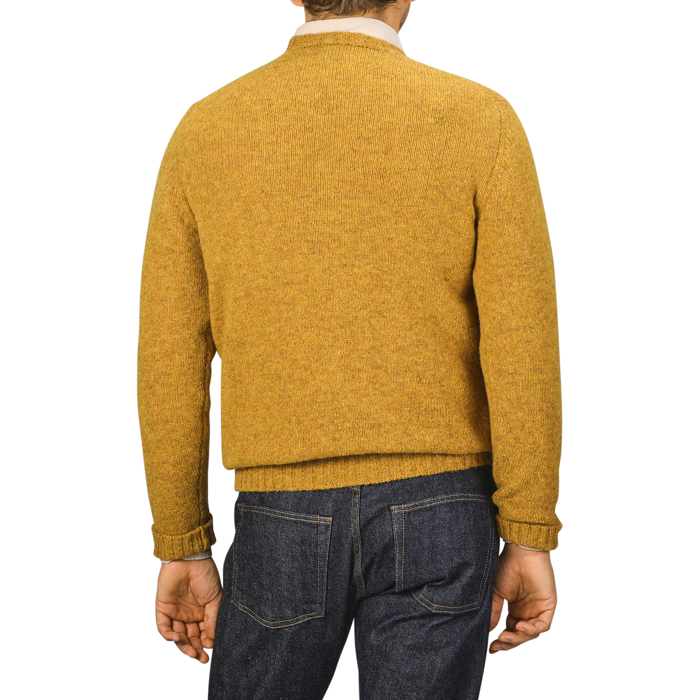 A person wearing a Cumin Brushed Shetland Lambswool Crew Neck by William Lockie, paired with dark jeans, is facing away from the camera.