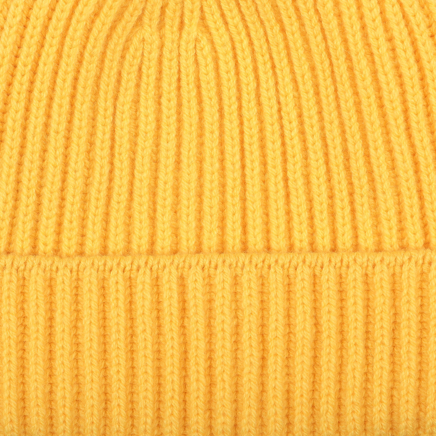 Close-up of a Daffodil Yellow Geelong Lambswool Ribbed Beanie by William Lockie, highlighting its soft ribbed texture.