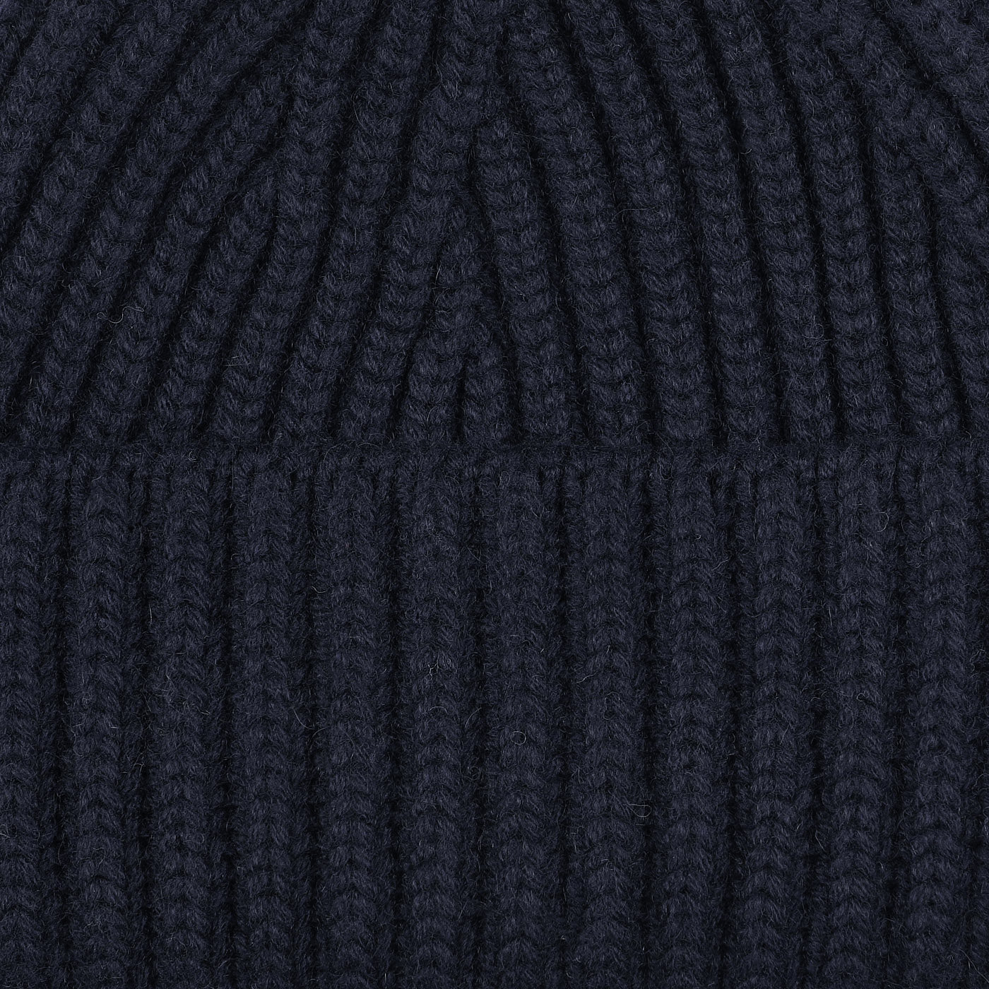 A close-up of the luxurious Dark Navy Cashmere Short Ribbed Beanie by William Lockie.