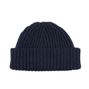 A luxurious William Lockie Dark Navy Cashmere Short Ribbed Beanie graces the black background, exuding elegance and warmth.