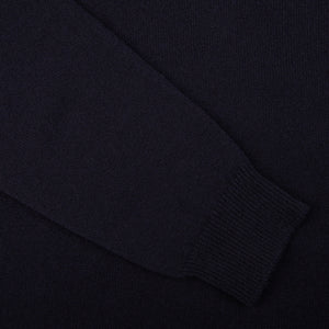 A close up of a William Lockie Dark Navy V-Neck Lambswool Sweater.