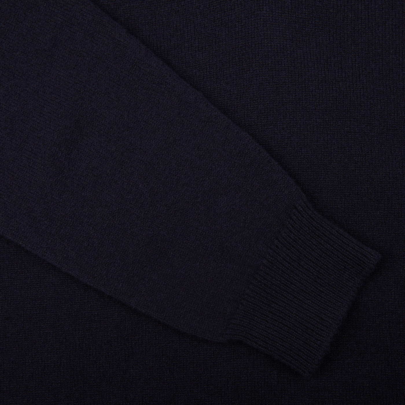 A close up of a William Lockie Dark Navy V-Neck Lambswool Sweater.