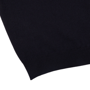 A comfy close up of a William Lockie Dark Navy V-Neck Lambswool Sweater.