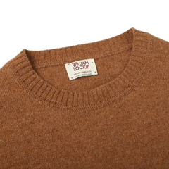 A Scottish Driftwood Crew Neck Lambswool sweater in brown, showcasing exquisite knitwear with a William Lockie label on it.