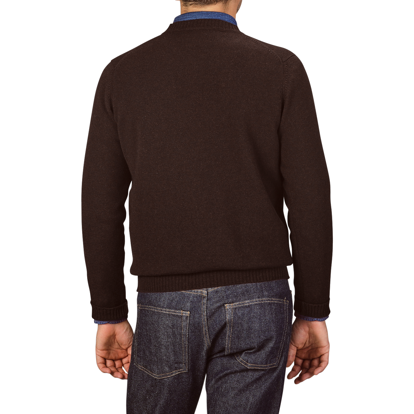 A person is standing with their back to the camera, wearing an Ebony Brown Crew-Neck Lambswool Sweater from William Lockie and blue jeans.