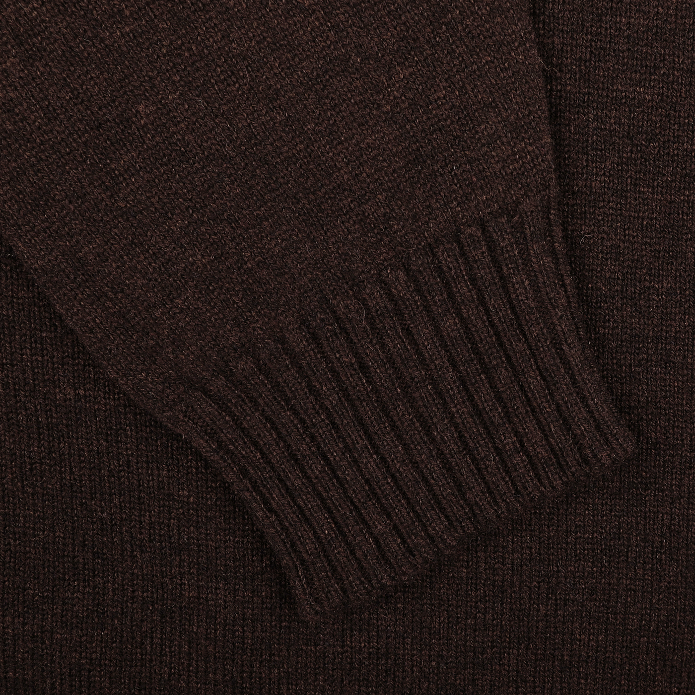 Close-up of the Ebony Brown Crew-Neck Lambswool Sweater by William Lockie, featuring a sleeve with ribbed cuffs. Perfect for smart casual knitwear occasions.