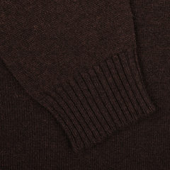 Close-up of the Ebony Brown Crew-Neck Lambswool Sweater by William Lockie, featuring a sleeve with ribbed cuffs. Perfect for smart casual knitwear occasions.