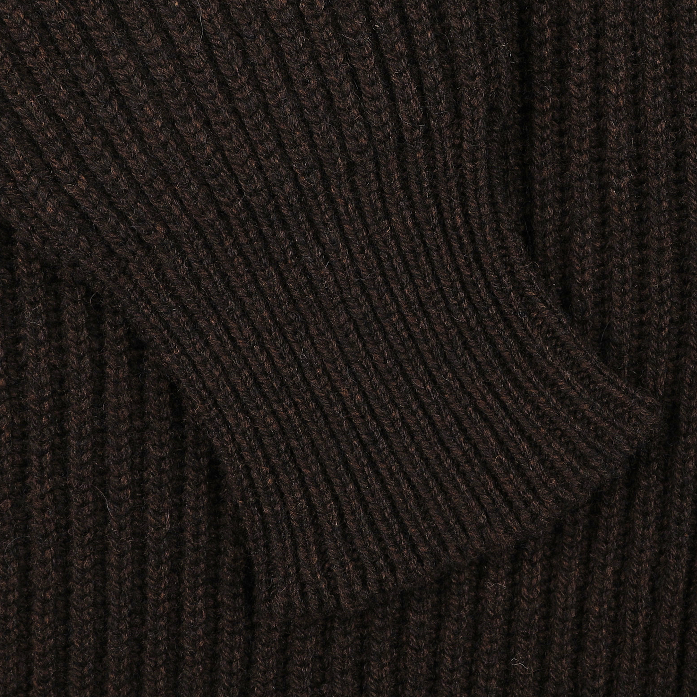 Close-up of the Ebony Brown Lambswool Shawl Collar Cardigan by William Lockie, showcasing its seamless, textured ribbed knit fabric with a rich dark brown hue.